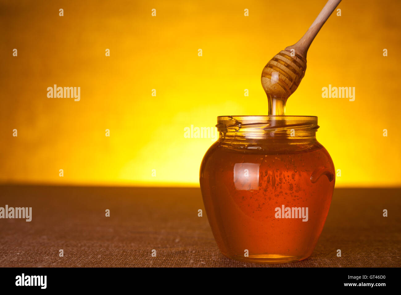 Honey jar with dipper Stock Photo Alamy