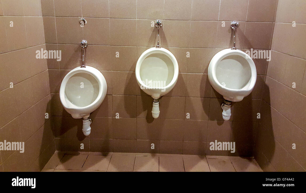 Urinals in public toilet for men Stock Photo