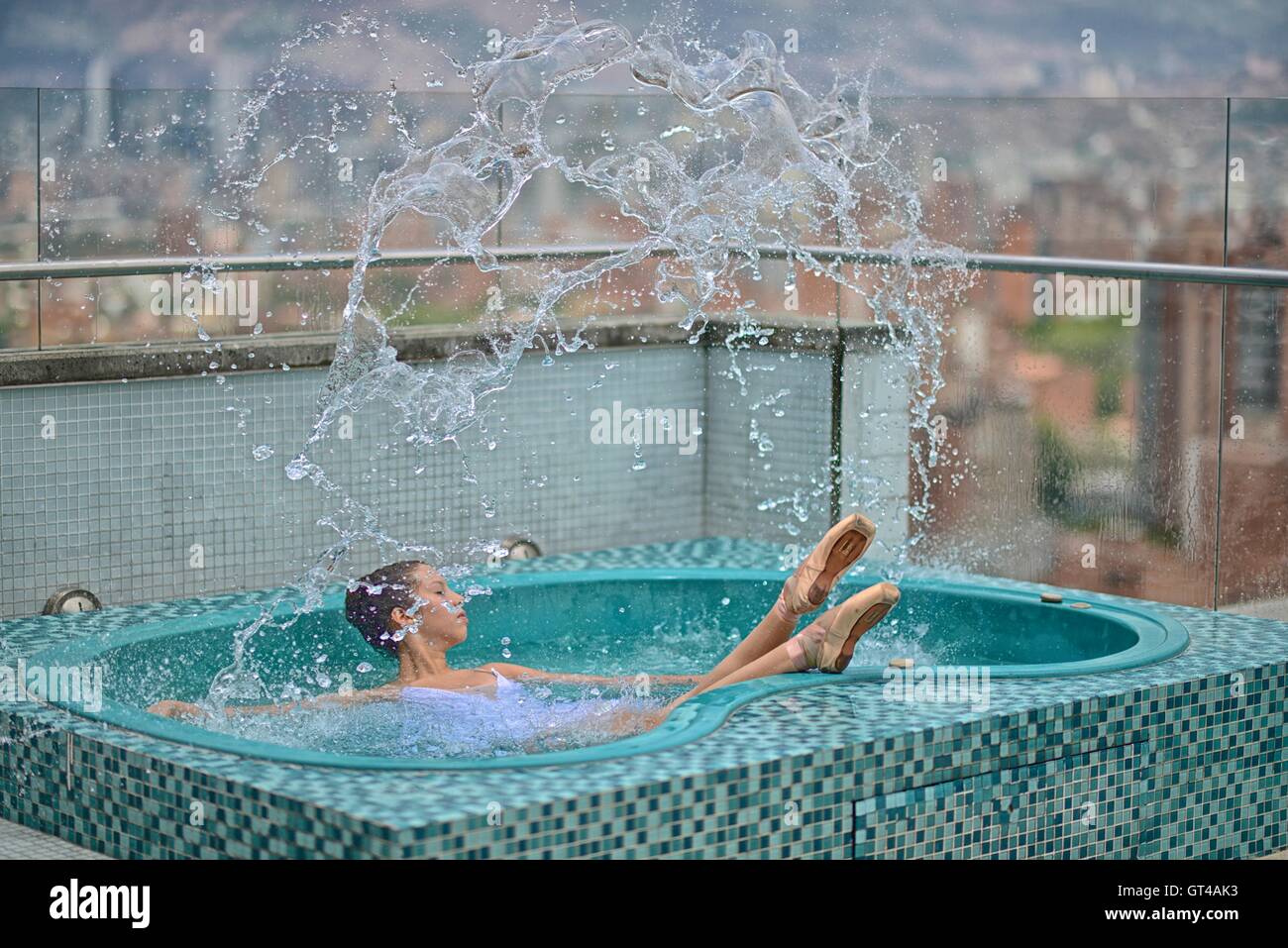 Ballerina in a rooftop jacuzzi in Medellin. Stock Photo