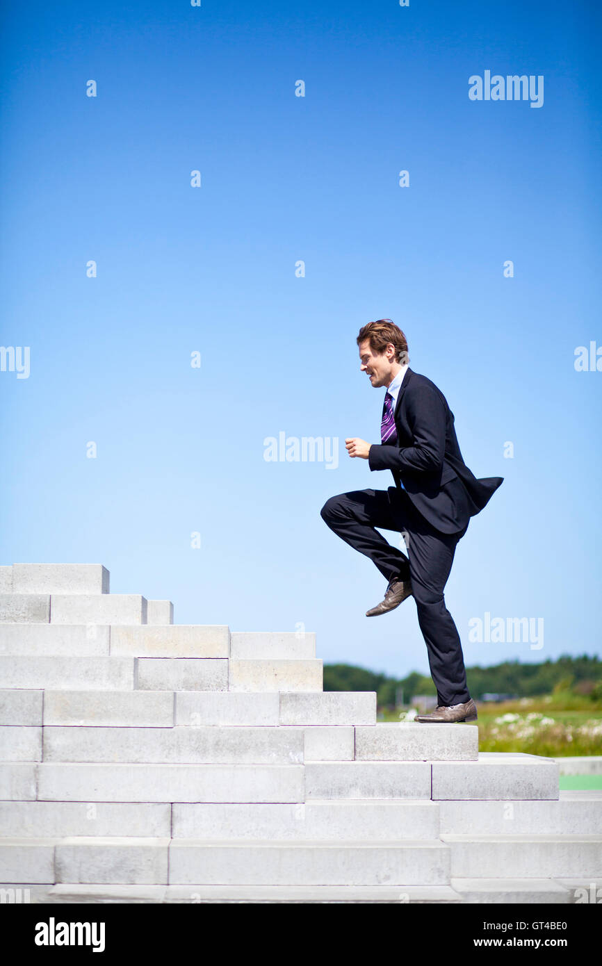 Businessman running up stairs Stock Photo - Alamy
