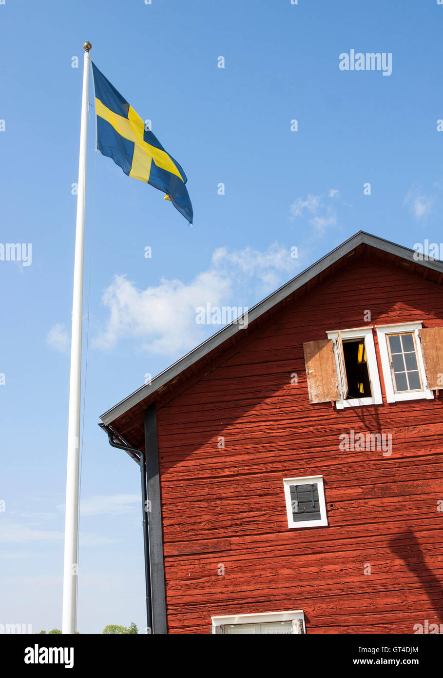 Old Swedish wooden house with flagpole Stock Photo