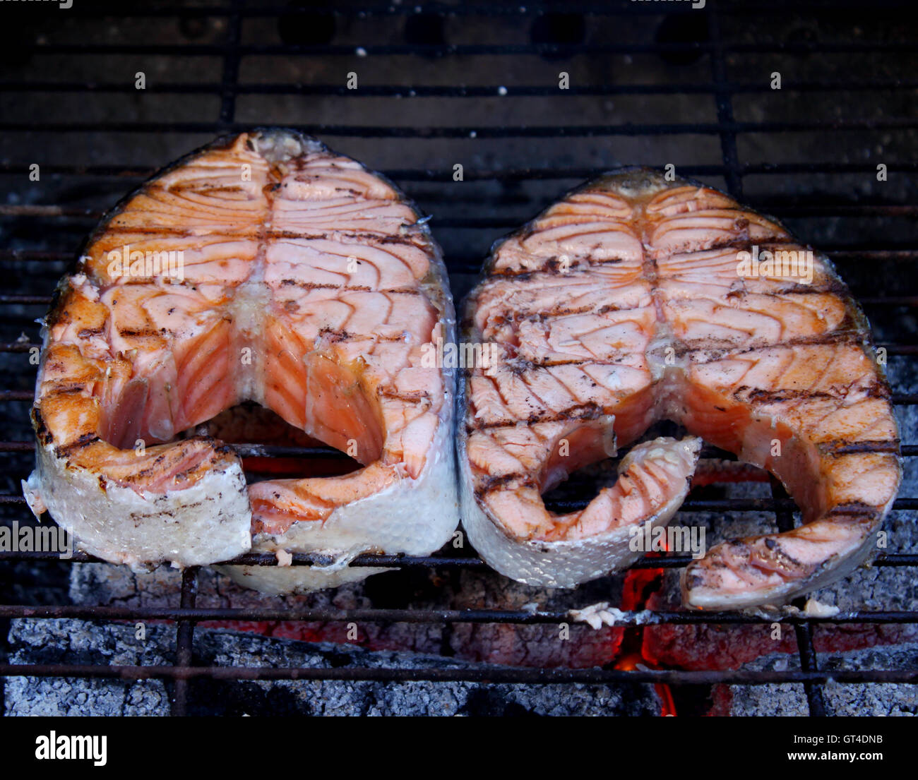 Two fresh salmon steaks cooked on BBQ Stock Photo - Alamy
