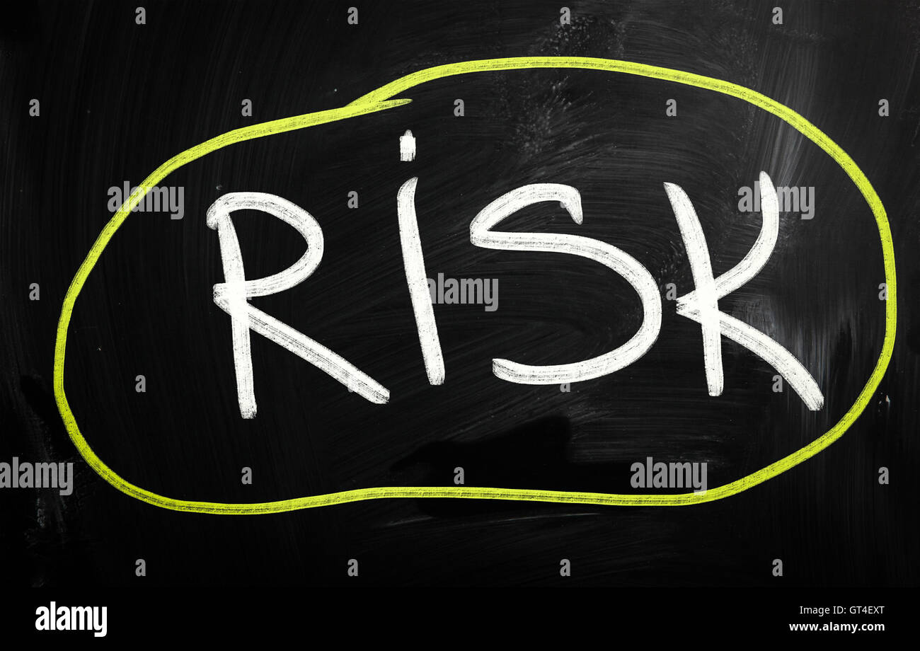 Risk handwritten with white chalk on a blackboard Stock Photo - Alamy