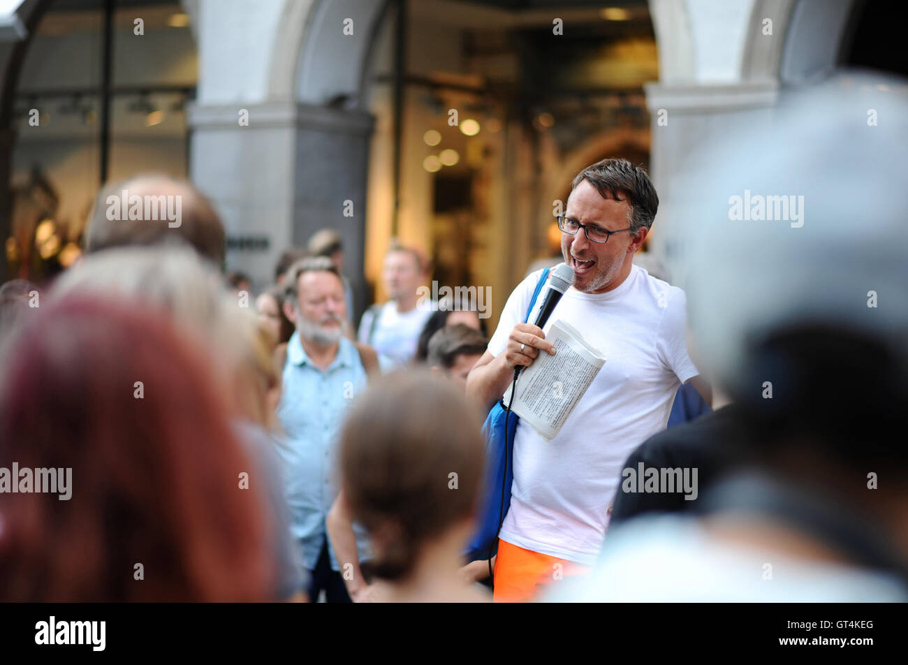 The London-born and Vienna-based city guide, Eugene Quinn, speaks to the around 100 participants in front of a building on Kaufinger-Strasse during the first 'Munich Ugly Tour' in downtown Munich, Germany, 08 September 2016. The city tour visits the ugliest corners of the Bavarian state capital. Photo: ANDREAS GEBERT/dpa Stock Photo