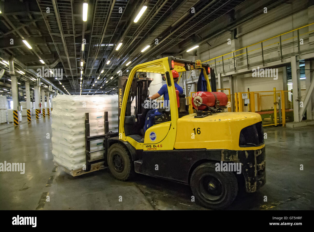 Forklift truck loads pallets with finished goods Stock Photo
