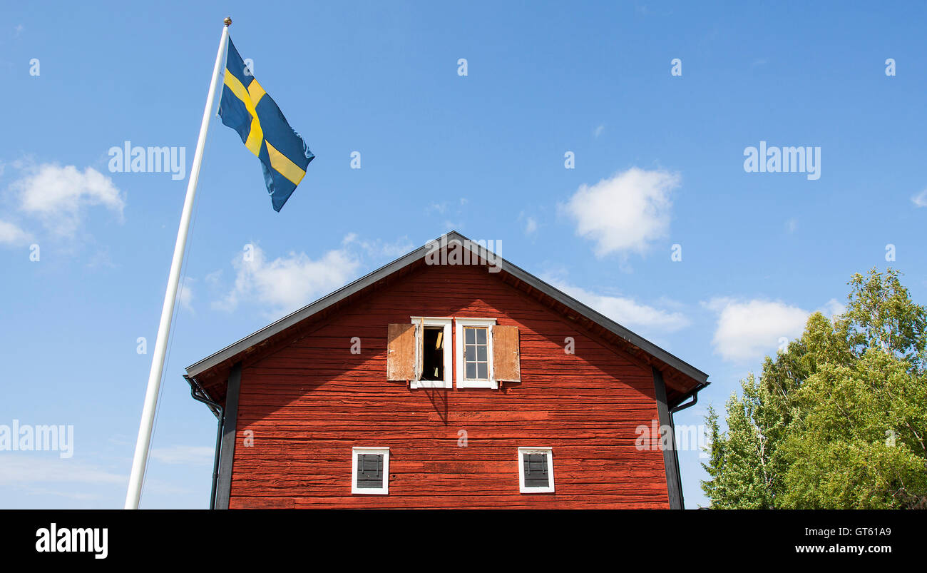 Old Swedish wooden house with flagpole Stock Photo