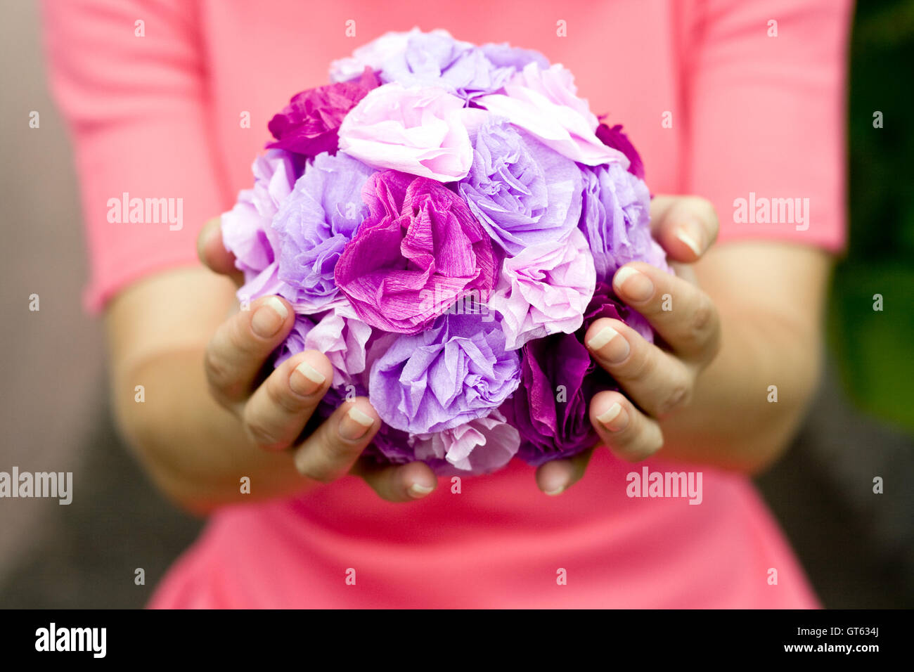 The girl in a pink dress holding a bouquet of purple flowers Stock ...