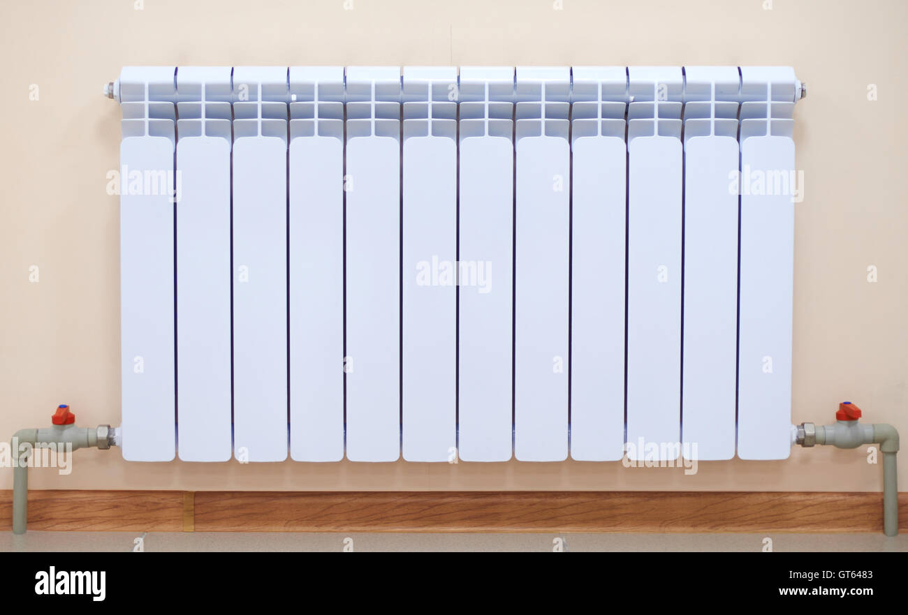 A radiator, pipes and taps Stock Photo Alamy