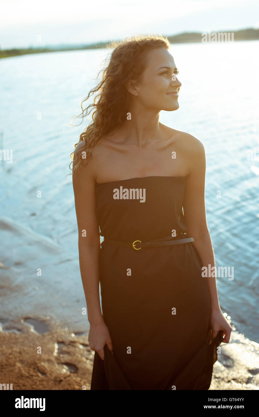 Beautiful girl walks on the banks of river Stock Photo - Alamy