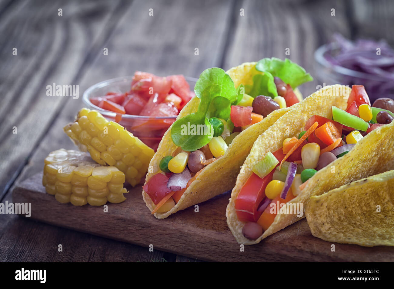 Mexican corn tortilla tacos with vegetables and grilled chicken on