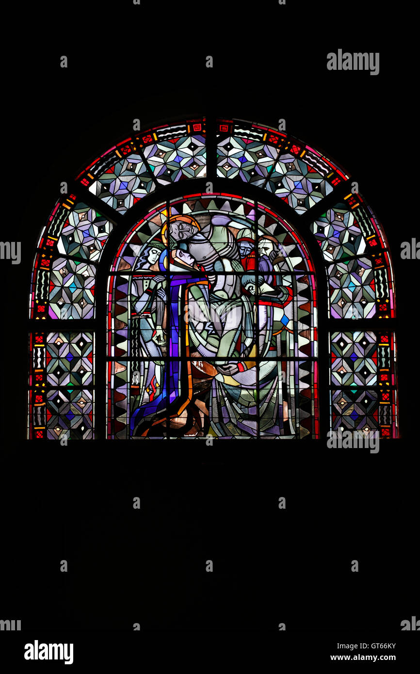 Stained glass in the Eglise de Coex. Depiction of  Jesus cut down from the cross. Stock Photo