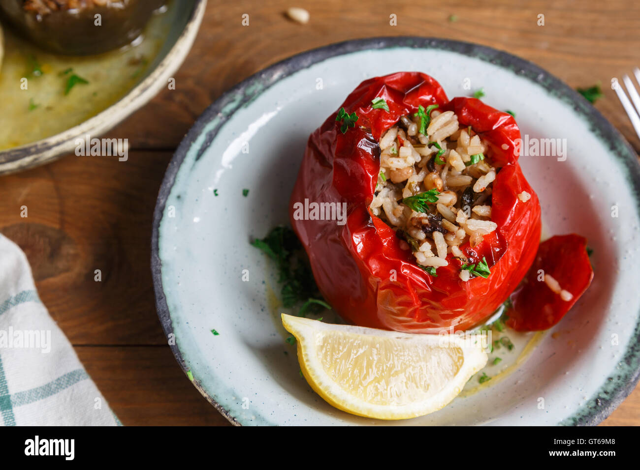 Red peppers stuffed with rice and vegetables Stock Photo