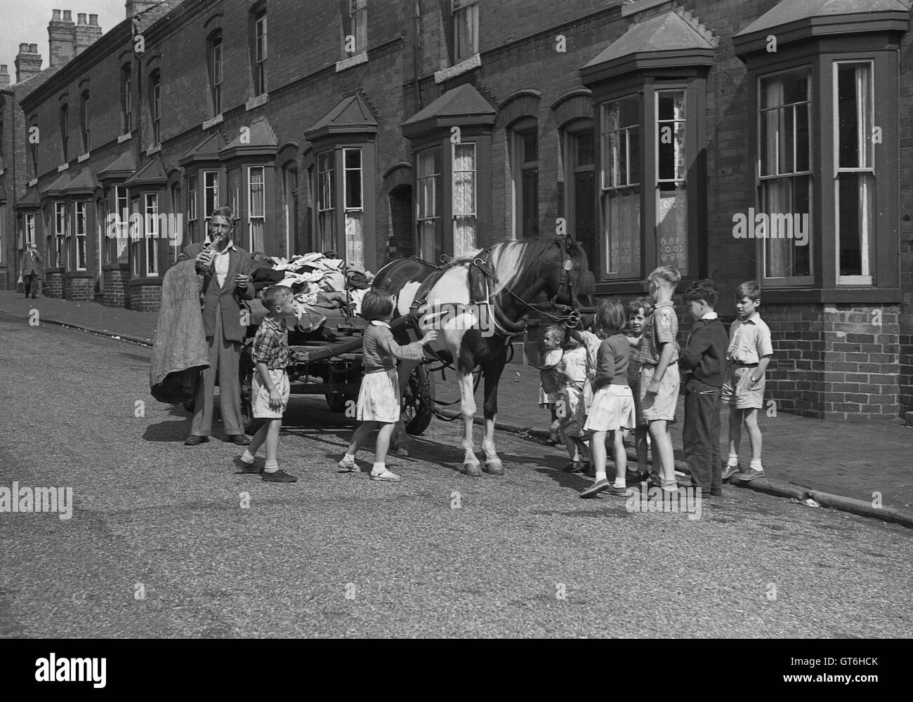 Rag and Bone man with horse and cart surrounded by children in street Birmingham West Midlands Uk 1950s Britain Stock Photo