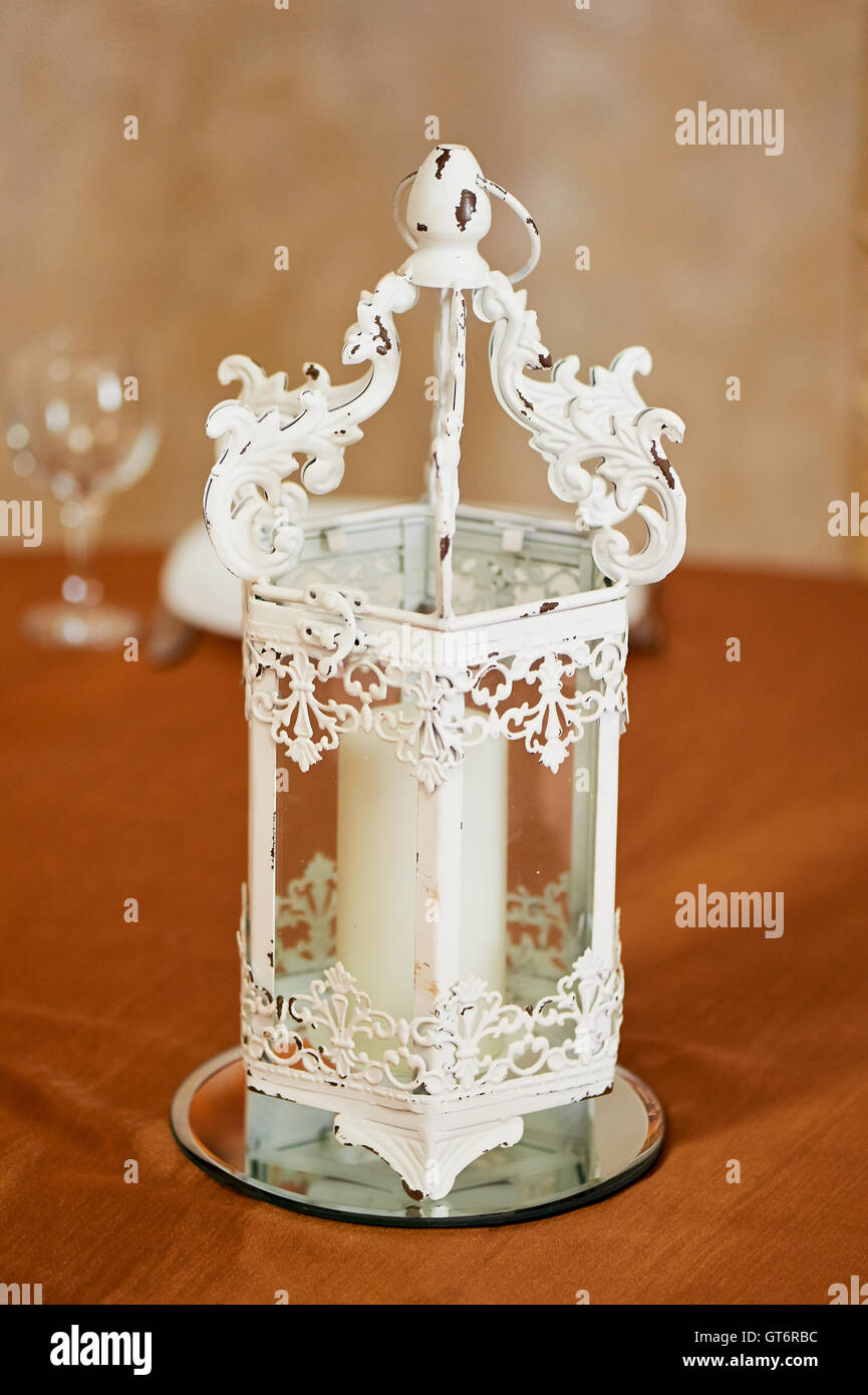White wrought-iron candlestick. The decor of the room. Stock Photo