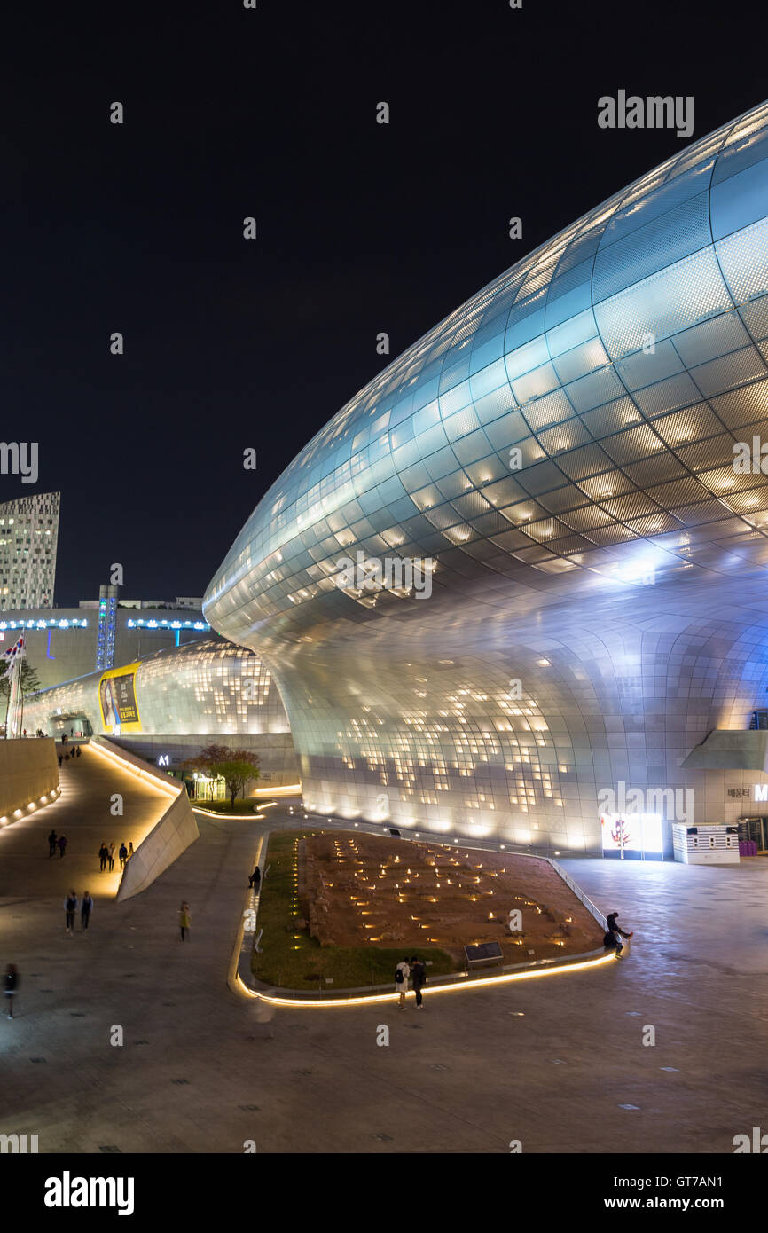 Plaza and side view of the futuristic Dongdaemun Design Plaza (DDP) in Seoul, South Korea at night. Stock Photo
