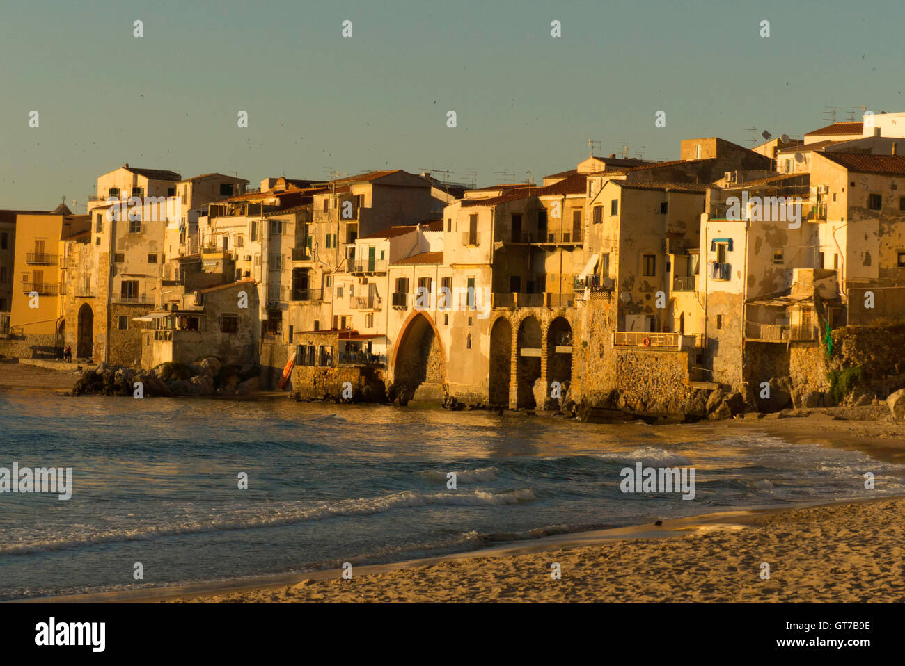Cefalu,Sicily shoreline late day beach and ancient housing Stock Photo