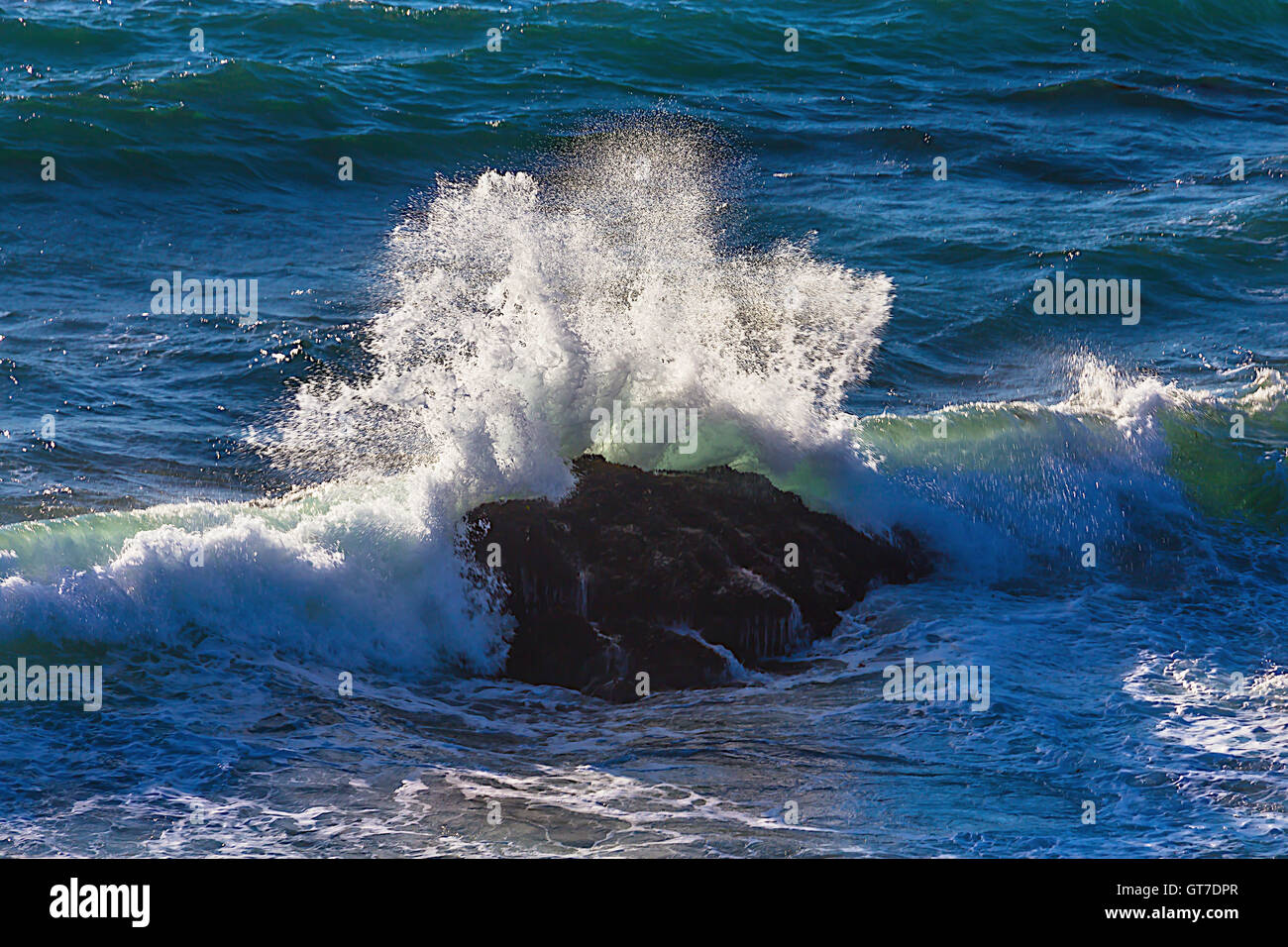 Wave breaking On Rocks Pacific Ocean Stock Photo