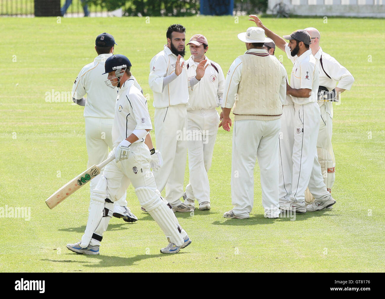 I Shah of Hainault & Clayhall clean bowls T Thompson (foreground) of Ardleigh Green and celebrates with his team mates - Ardleigh Green CC vs Hainault & Clayhall CC - Essex Cricket League Cup at Central Park - 02/05/09. Stock Photo