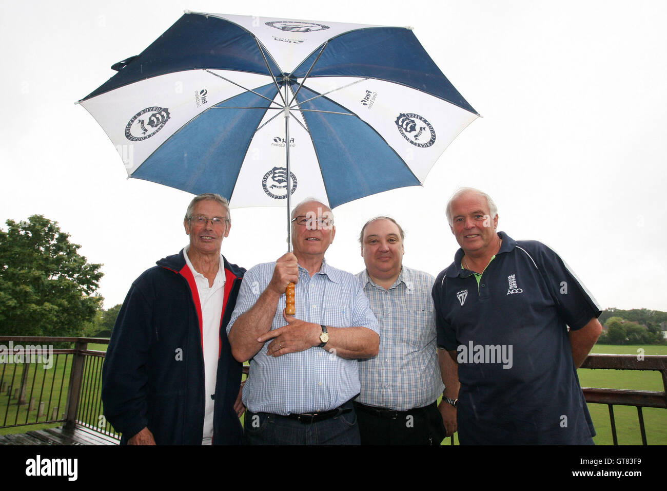 Umpires (from L) Roy Saunders, Tom Kilby, Dave Griffiths and Mick Tucker take shelter from the rain at Gallows Corner - Essex Cricket League - 16/07/11 - contact@tgsphoto.co.uk Stock Photo