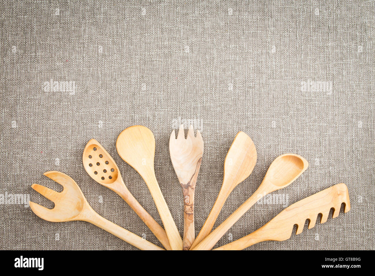 https://c8.alamy.com/comp/GT8B9G/fanned-display-of-a-variety-of-different-wooden-kitchen-utensils-arranged-GT8B9G.jpg