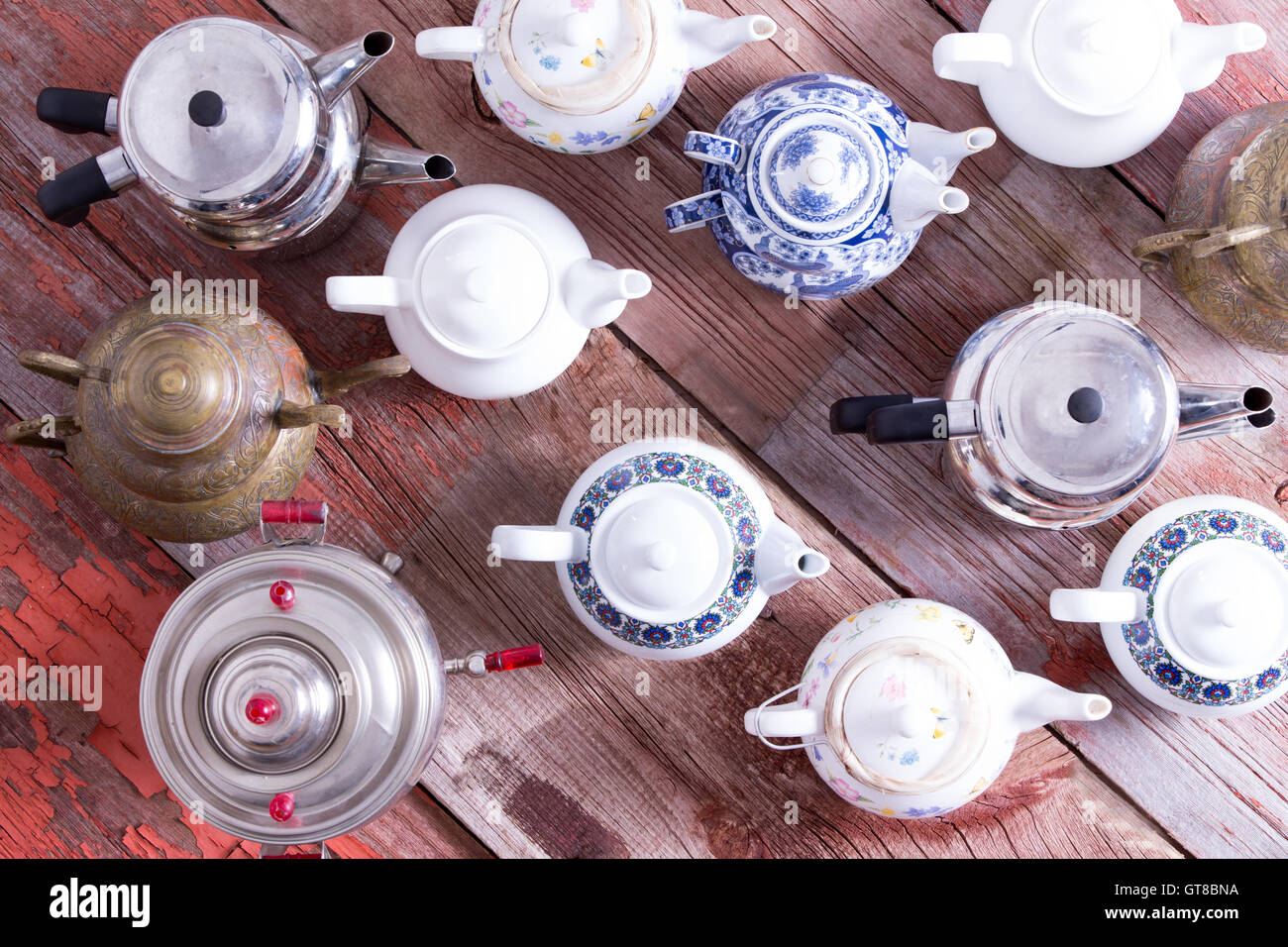 Army of a assorted metal and ceramic Turkish and conventional tea pots arranged in regimental rows all facing the same direction Stock Photo