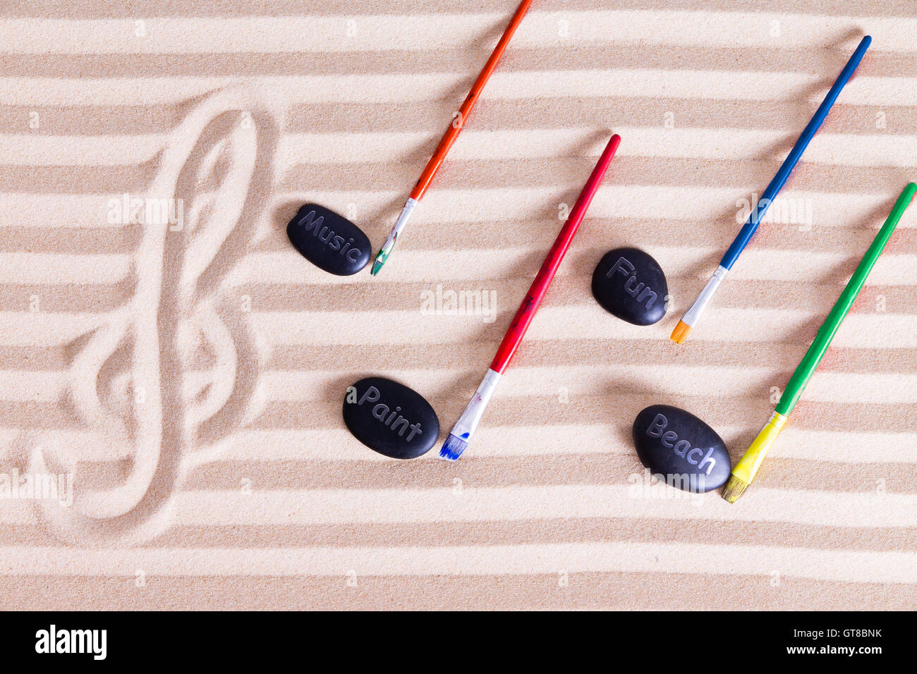 Music, Paint and Fun at the Beach for Resort Activities, G clef at the left  music notes made out of colorful paint brushes and b Stock Photo - Alamy
