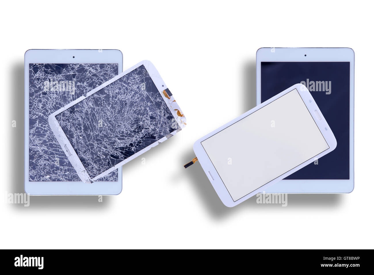 Overhead view of two tablets with shattered glass screens alongside two
