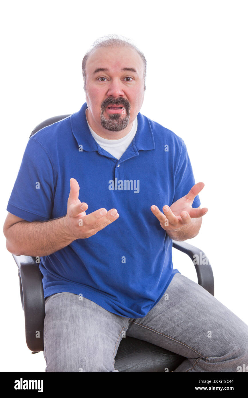 Close up Adult Guy with Beard and Mustache, Sitting on a Chair and Questioning Something Gesture While Looking at the Camera. Is Stock Photo