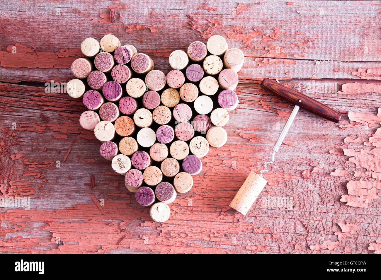 Close up Corks in Heart Shape and Wine Bottle Opener on Top of a Rustic Wooden Table for Love Concept. Captured in High Angle Vi Stock Photo