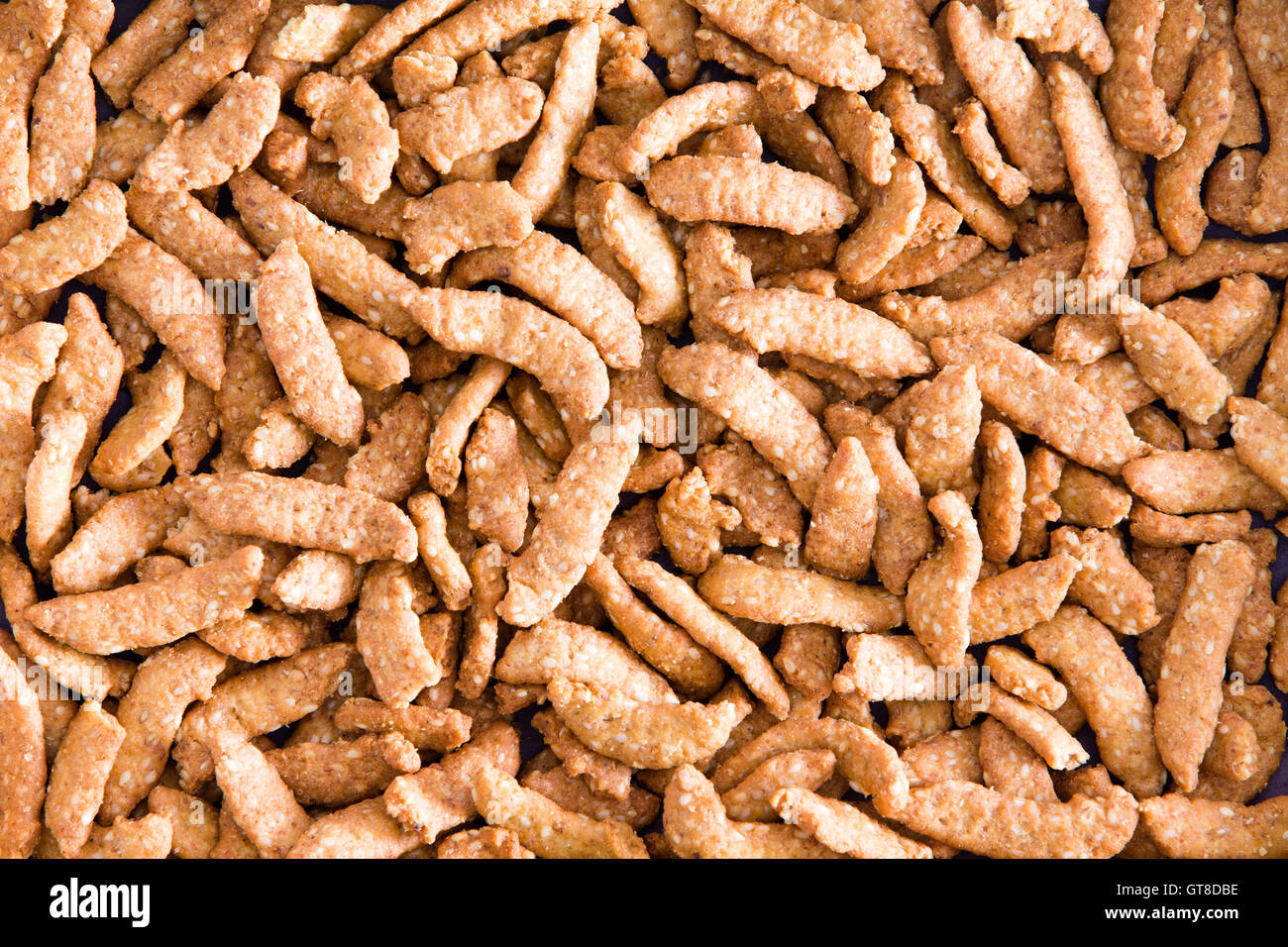 Background texture of healthy crunchy sesame seed sticks for a tasty nutty flavored snack or appetizer Stock Photo