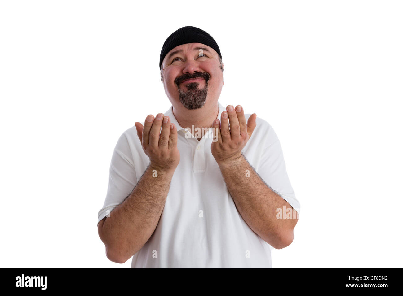 Middle-aged casual man with a goatee imploring God to find a solution raising his hands in supplication and looking up to heaven Stock Photo