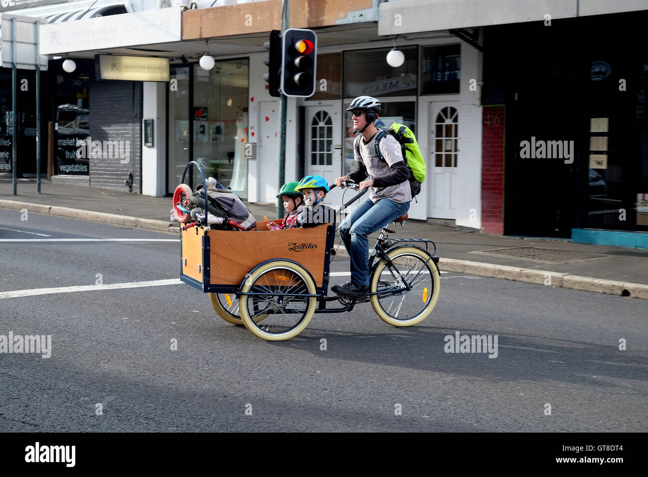 A man pedals his children on a bicycle in the Sydney suburb of Newtown. Stock Photo