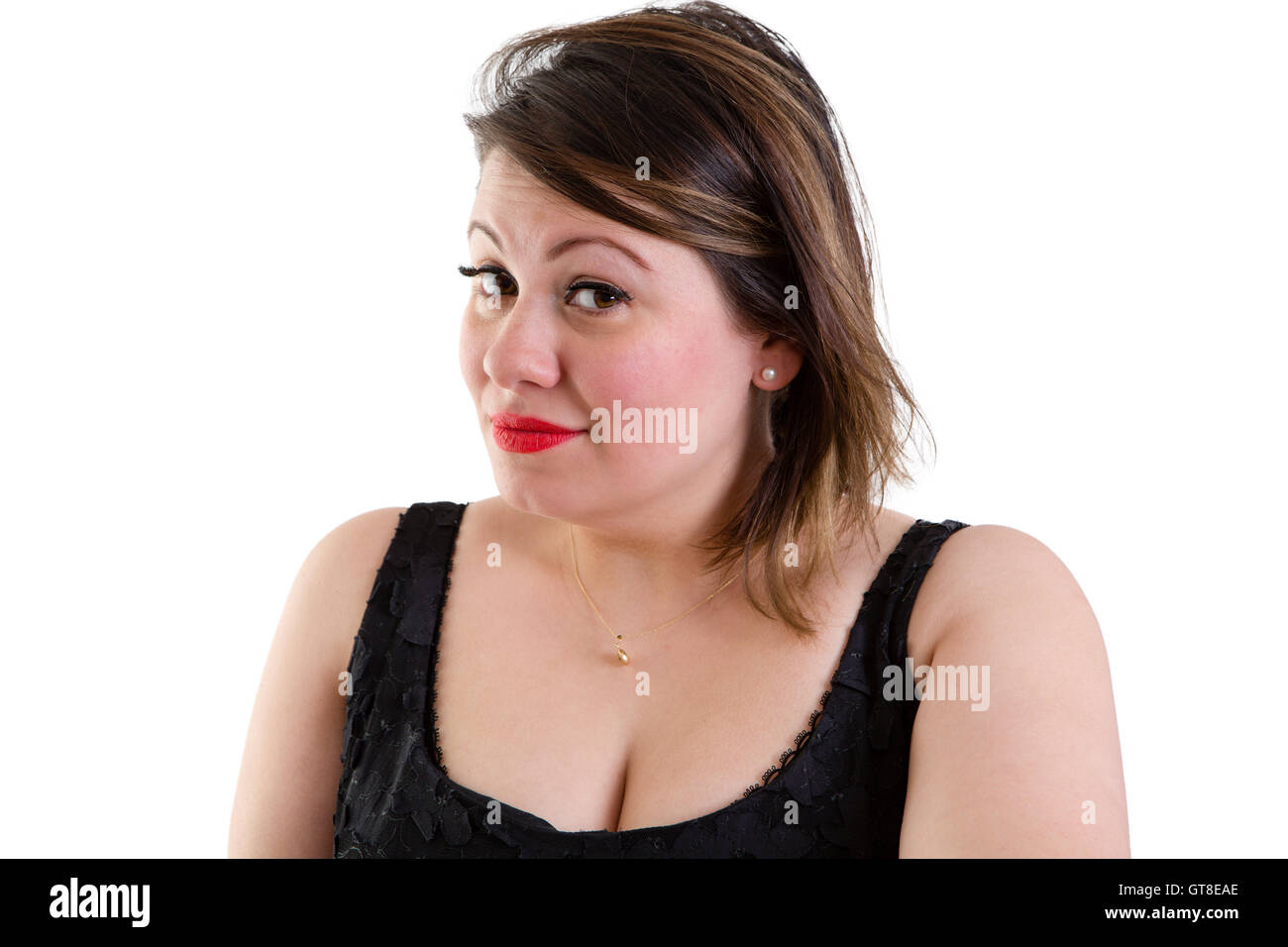 Sceptical woman with raised eyebrows looking sideways at the camera with a quizzical expression showing her incredulity and dist Stock Photo