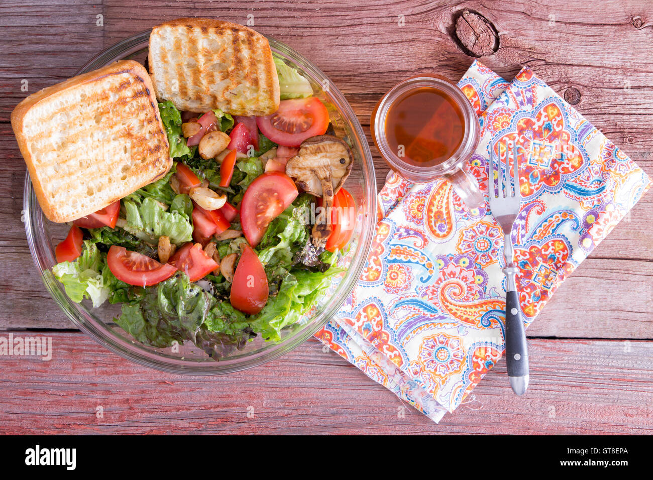 Healthy mixed leafy green salad with lettuce, tomato, garlic, sesame