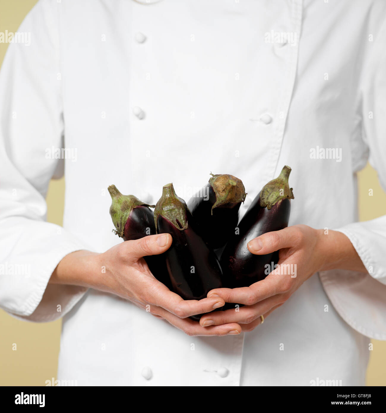 Close-up of Woman's Hands holding Eggplants Stock Photo