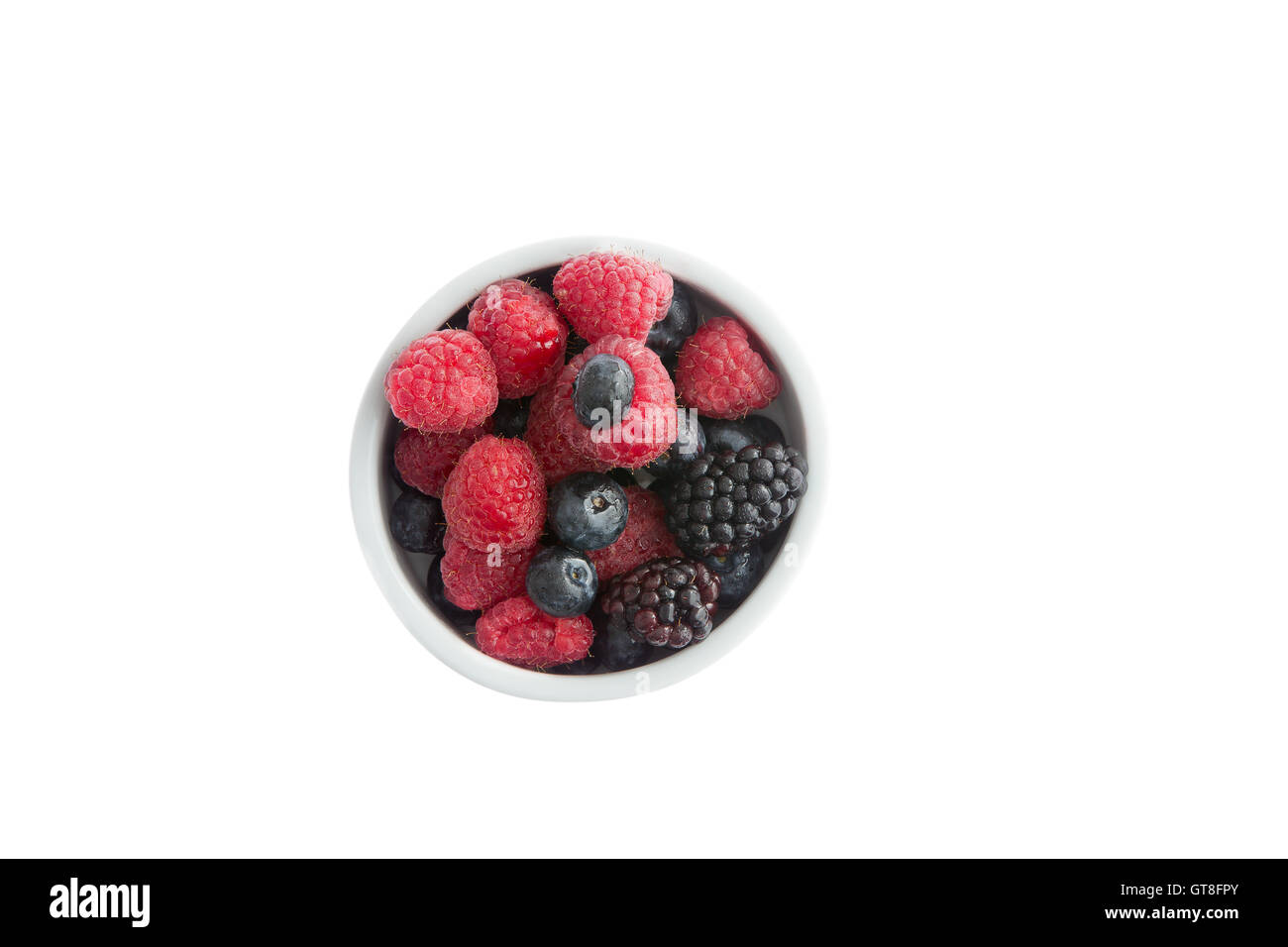 Ramekin of fresh fall or autumn berries with whole juicy ripe blueberries, blackberries and raspberries for a healthy breakfast, Stock Photo