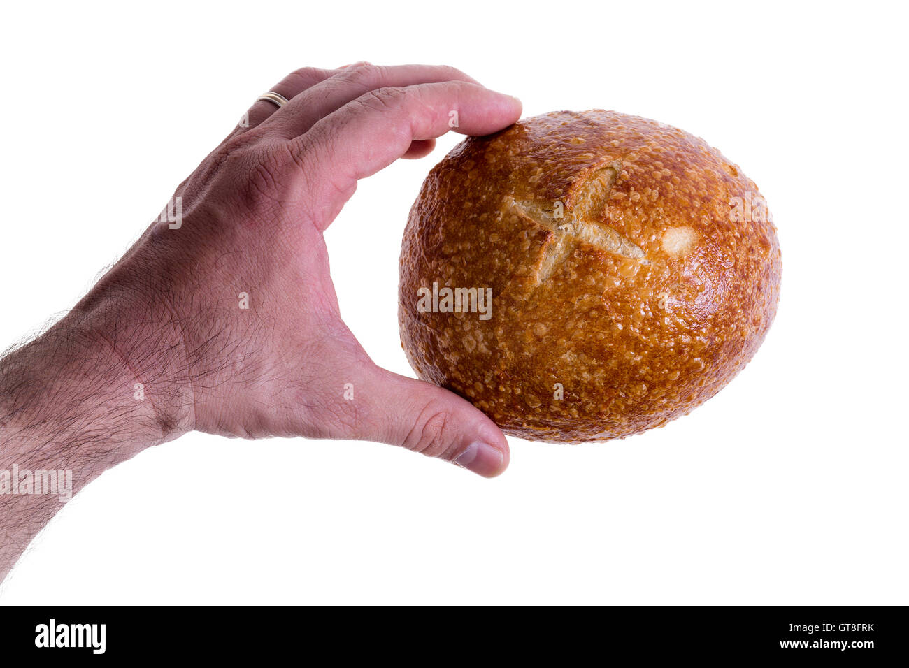 Clean male hand gently holding a freshly baked sourdough bread roll or round bun between finger and thumb isolated on a white ba Stock Photo