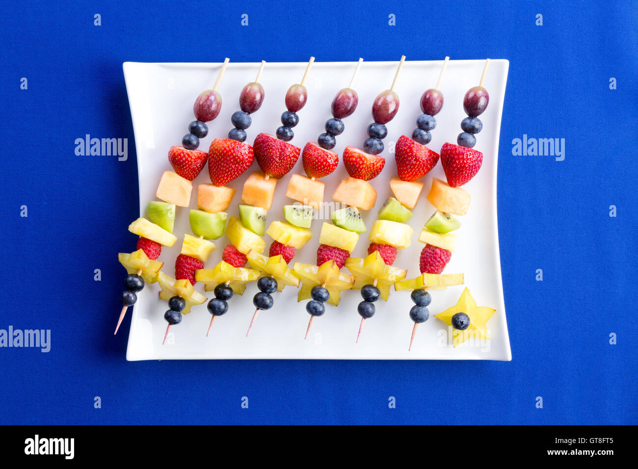 Healthy fruit kebabs with tropical seasonal summer fruit arranged