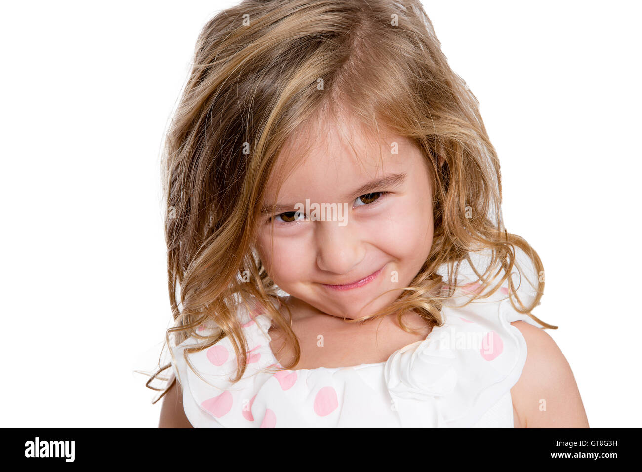 Close up Charming Blond Little Girl Smiling to You Shyly Against White Background. Stock Photo