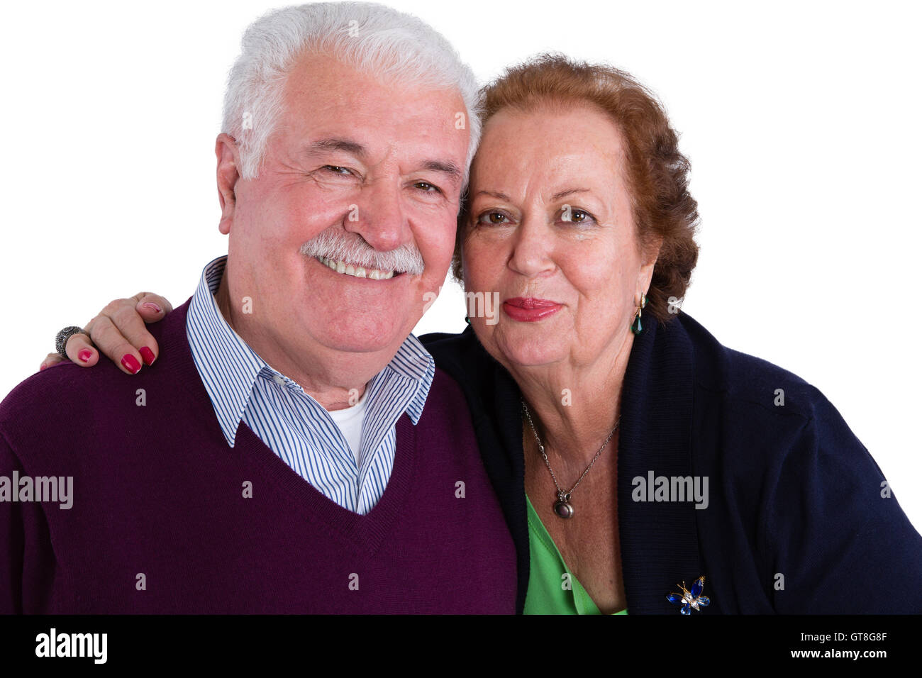Happy loving senior couple posing in a close embrace smiling happily at the camera, head and shoulders portrait isolated on whit Stock Photo