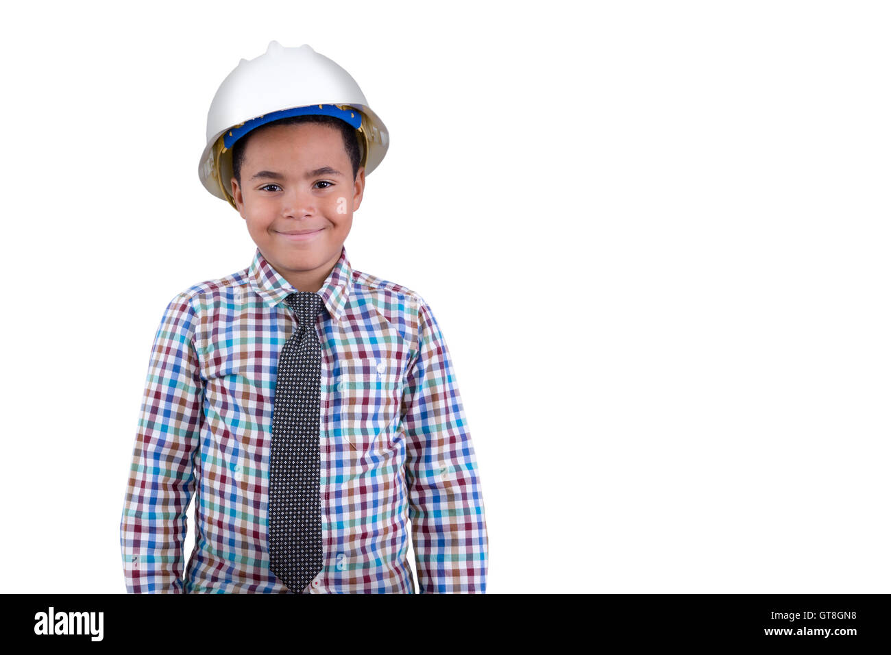 Future young African American engineer with a portrait of a charismatic young tween boy in a hardhat and necktie standing grinni Stock Photo