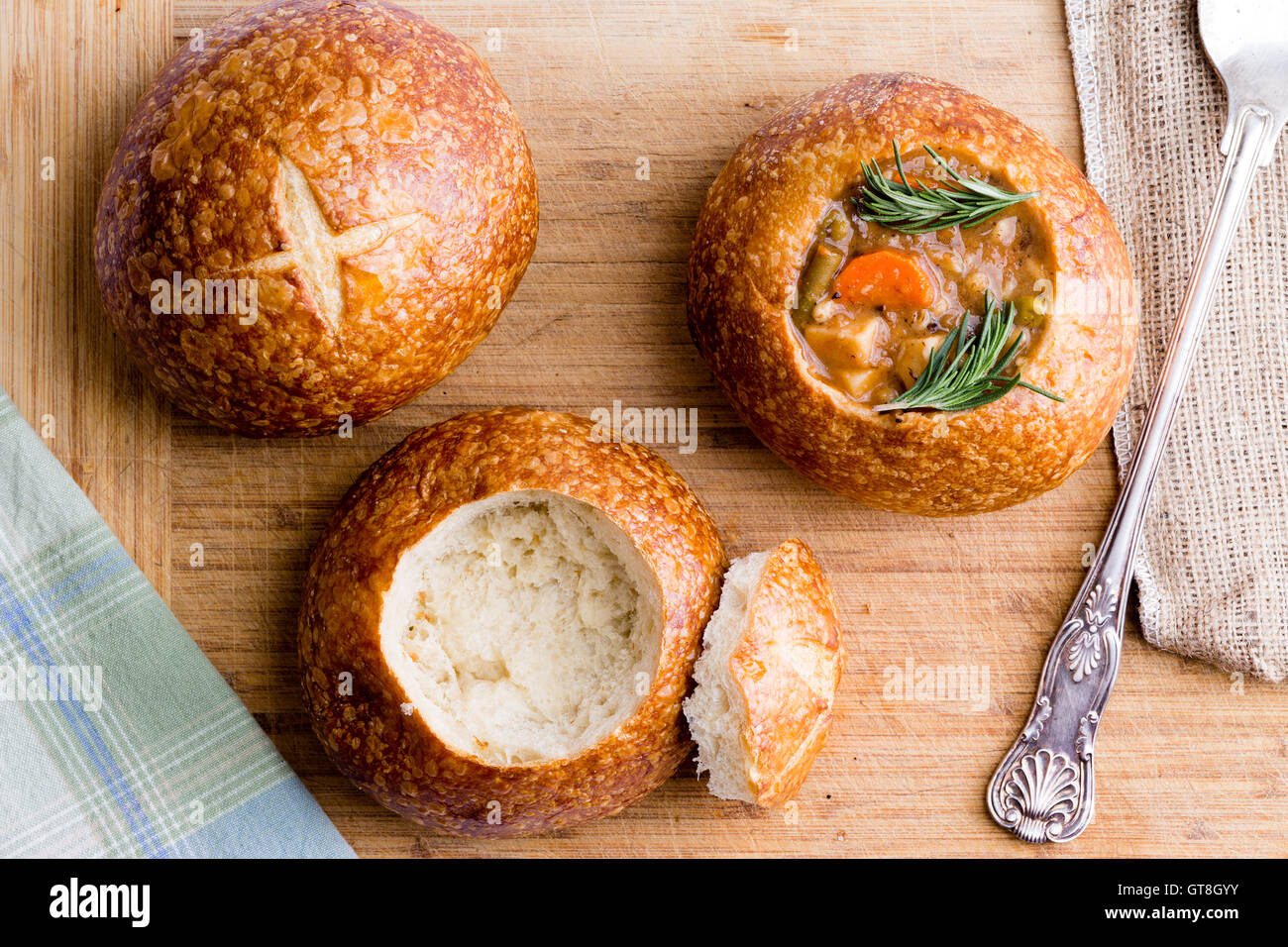 Stages in serving fresh vegetable soup in a sourdough bread bowl