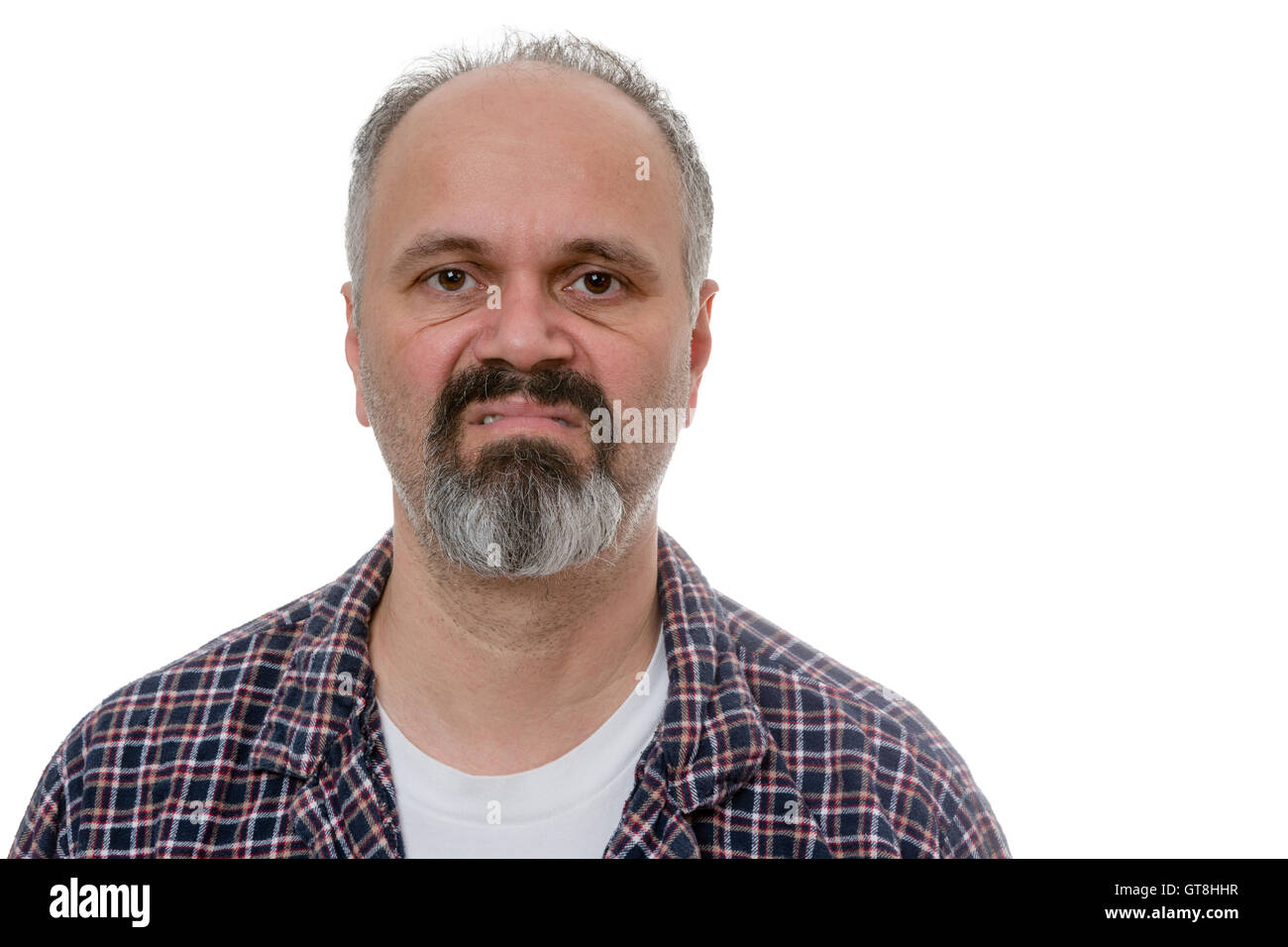Single balding grumpy old man in beard, mustache and plaid pyjamas with angry expression over white undershirt Stock Photo