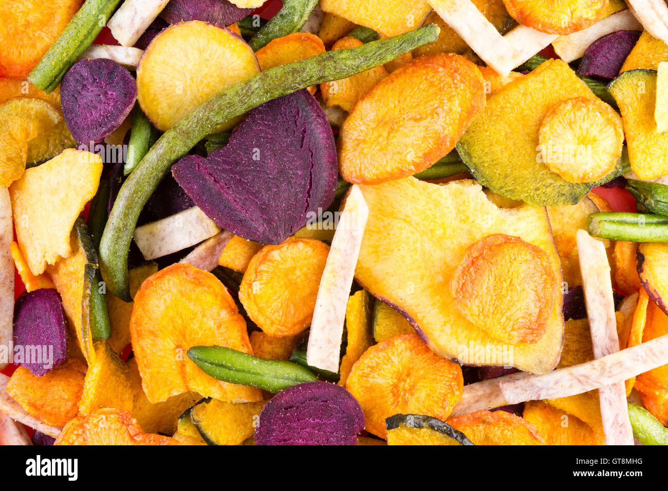 Background food texture of organic healthy veggie chips made form an  assortment of colorful dried sliced vegetables in a full fr Stock Photo -  Alamy, image size:1300x956