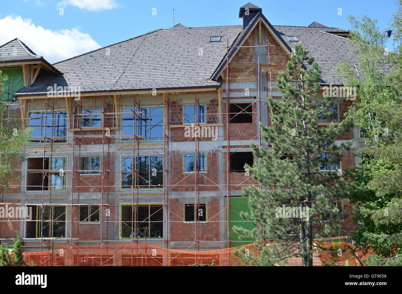 Close up of building on construction yard with scaffolds installed on ...