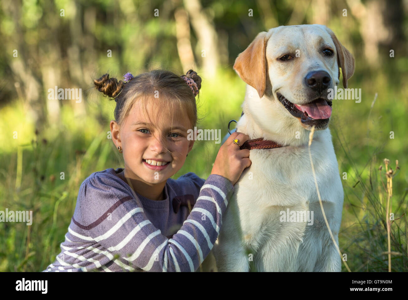 Happy little girl with her dog Stock Photo - Alamy