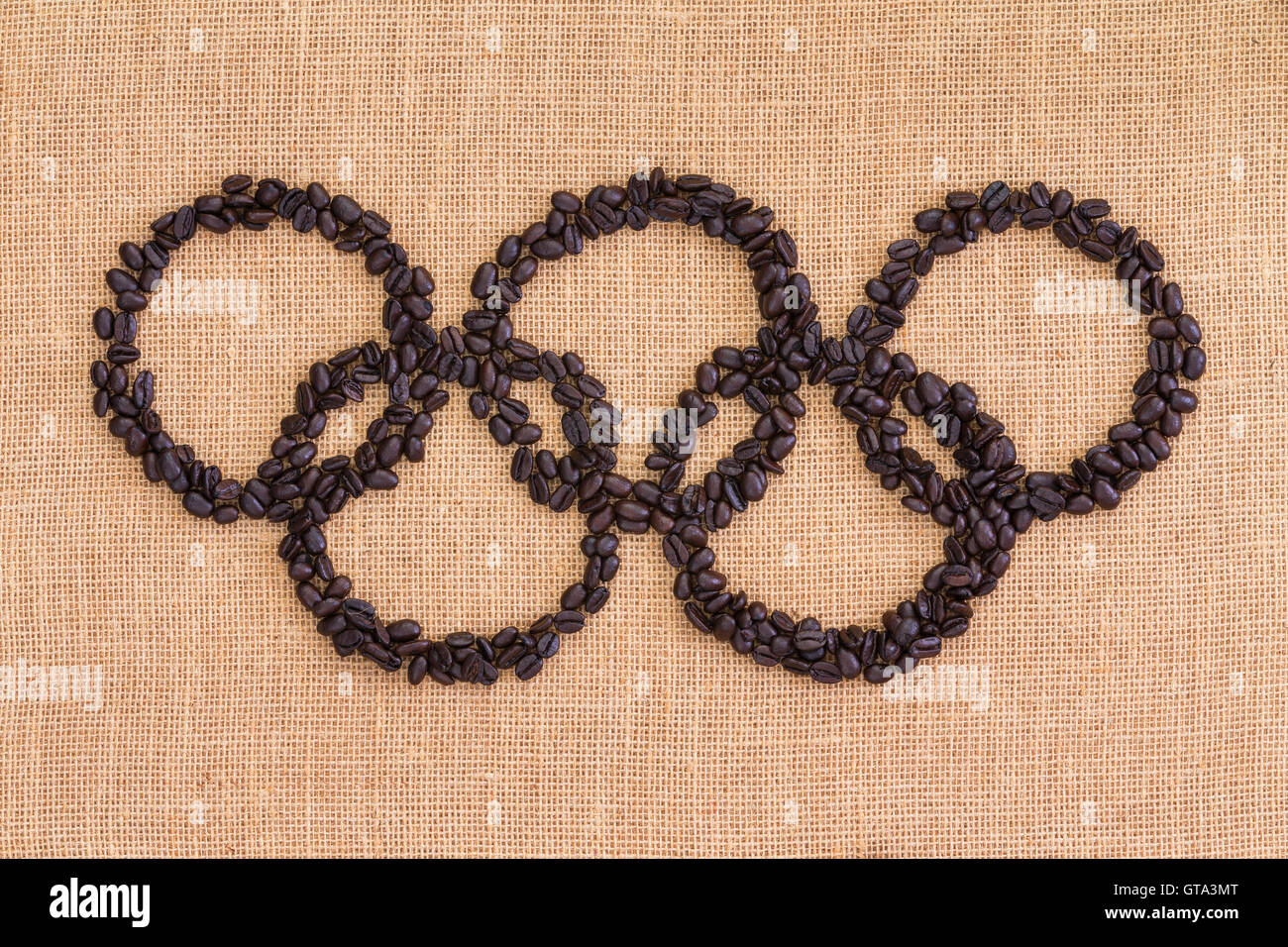 Olympic Games sign formed of roasted brown coffee beans on a natural