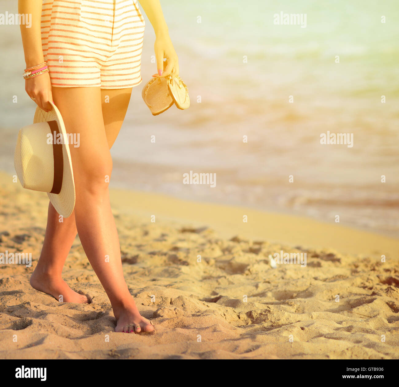 Beach travel - woman walking on sand beach leaving footprints in the ...