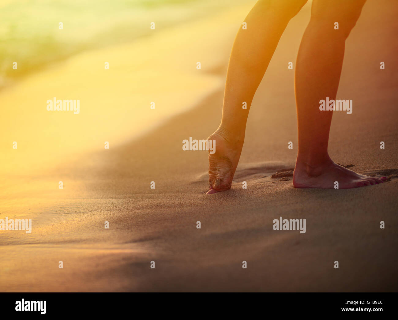 Beach travel - woman walking on sand beach leaving footprints in the ...