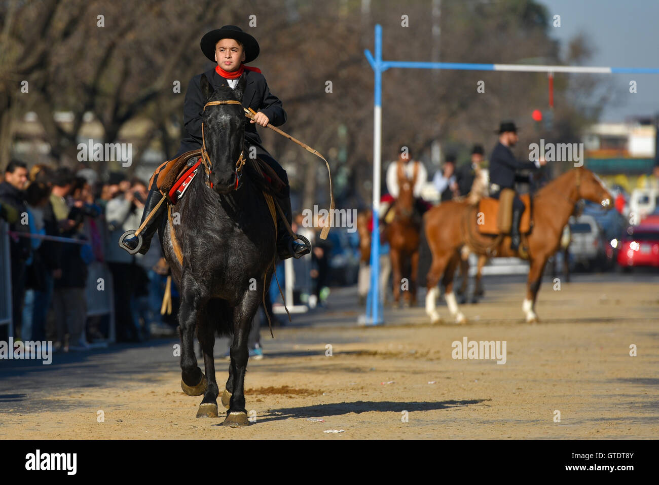 Buenos Aires, Argentina. 12 Jun 2016. A young gaucho rides his horse as he participates in the Corrida de sortija game. Stock Photo